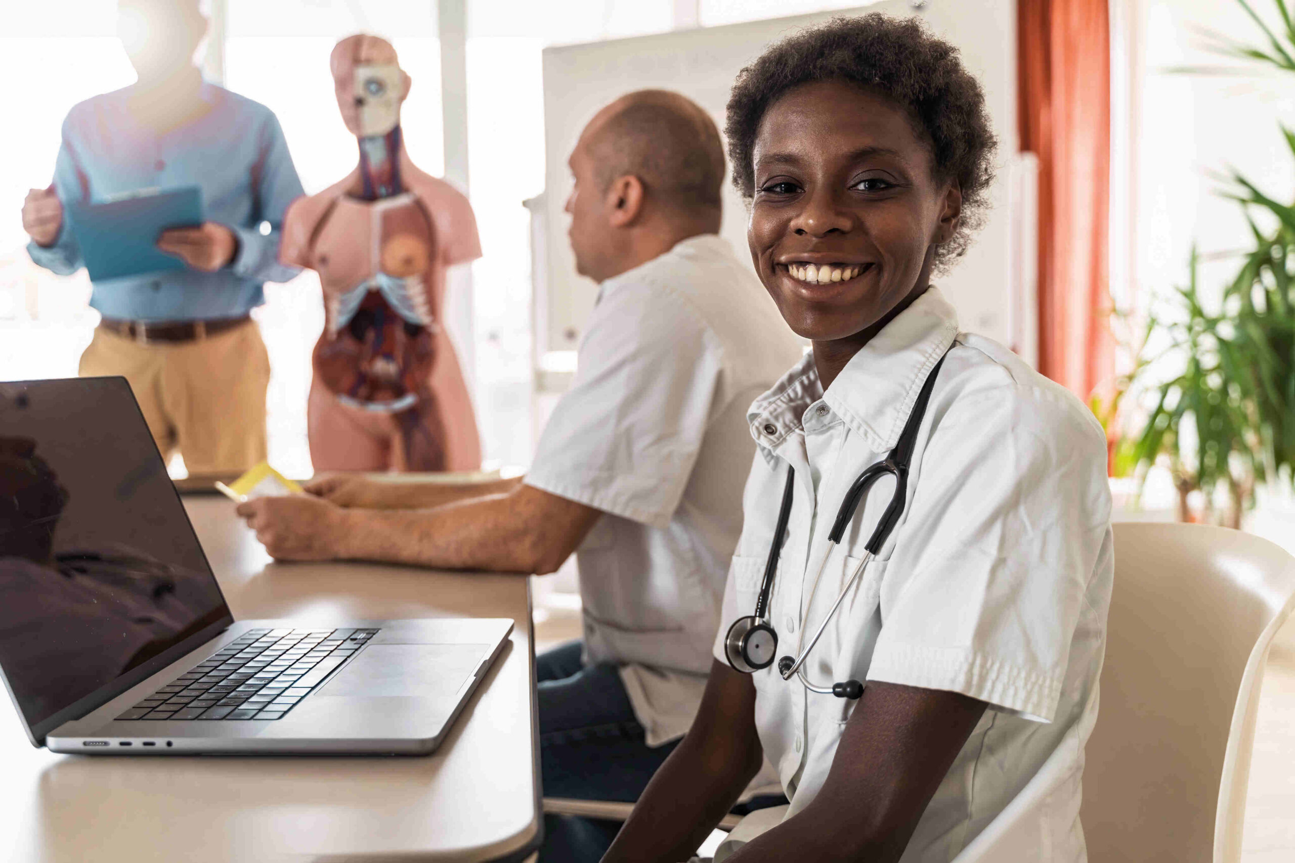 A medical scribe documenting an encounter on a laptop while working remotely